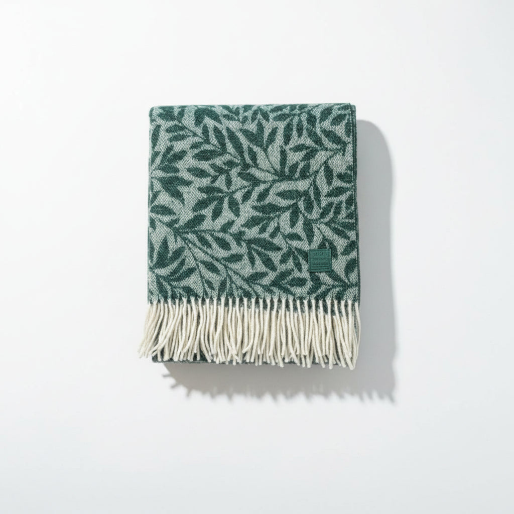 Green scarf with leaf pattern and white fringe